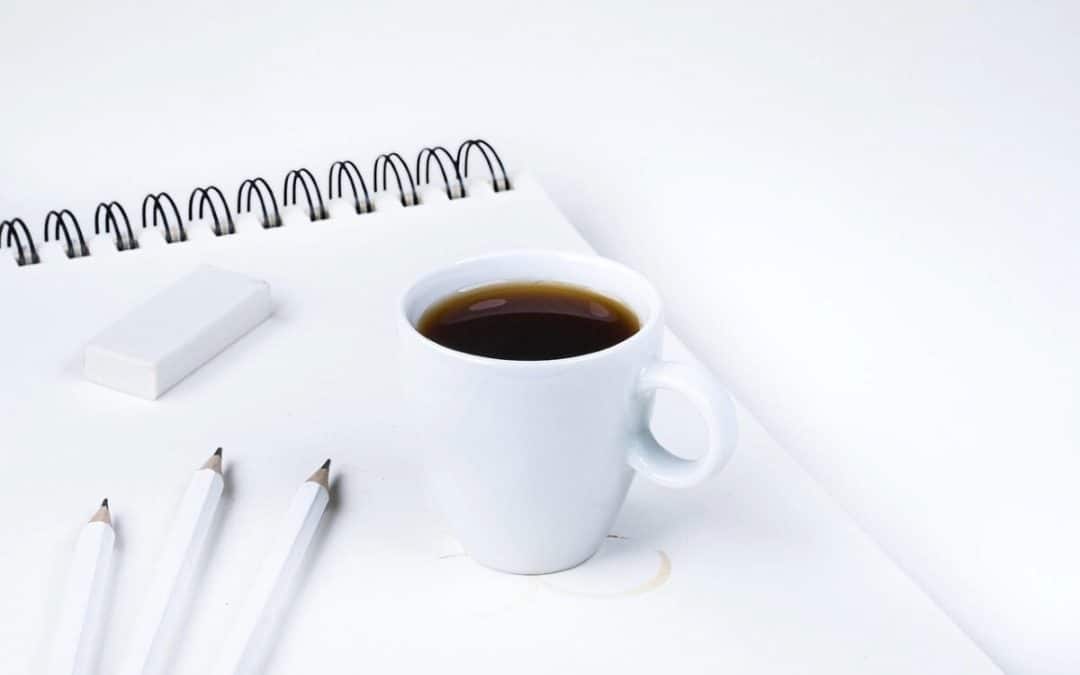 A quiet moment to think things through whether mediation is cheaper than using solicitors - coffee, notebook and pencils