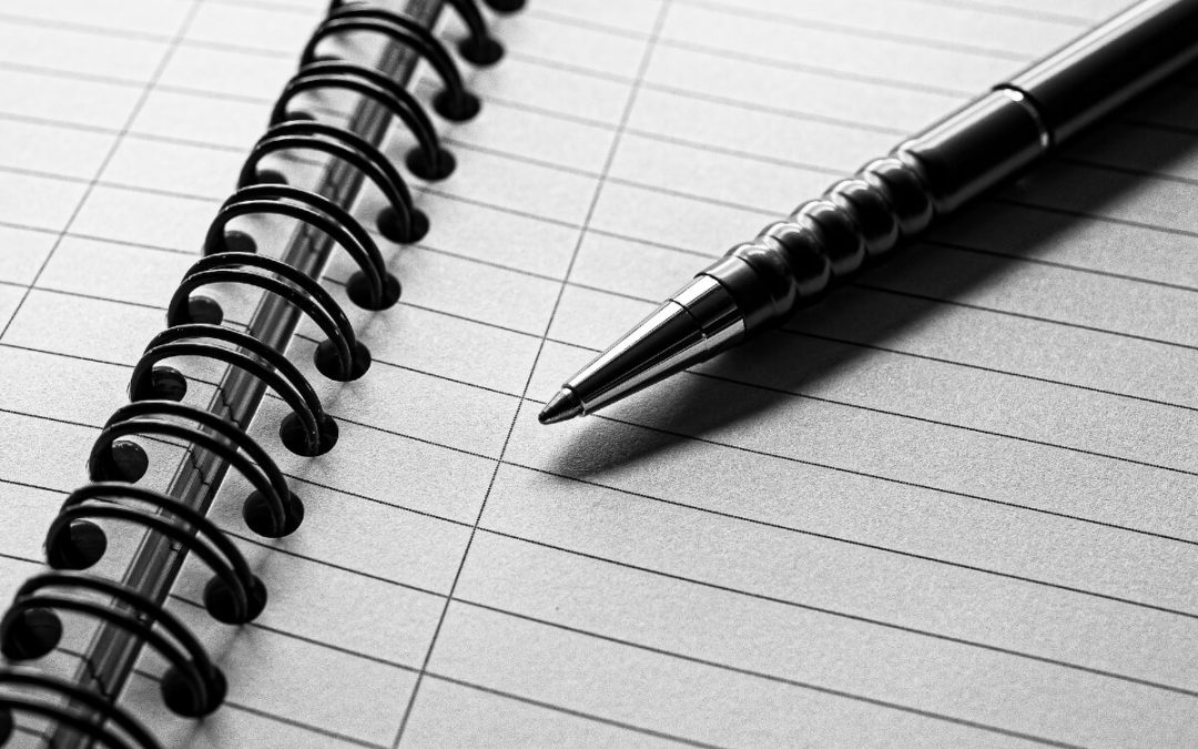 pen and paper representing reviewing retirement finances and pension plans before divorce