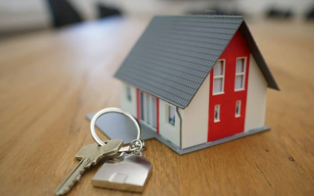 Model family home and house keys representing the practical and financial impact of divorce